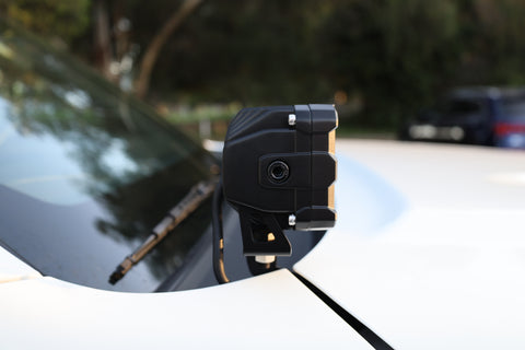 Close-up of a 2025 Nissan Frontier ditch light mounted on a vehicle's hood.