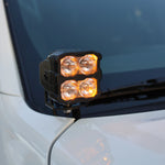 2025+ Nissan Frontier ditch lights PRO mounted on white vehicle, featuring amber daytime running lights.