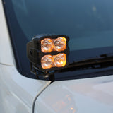 2025+ Nissan Frontier ditch lights PRO mounted on white vehicle, featuring amber daytime running lights.
