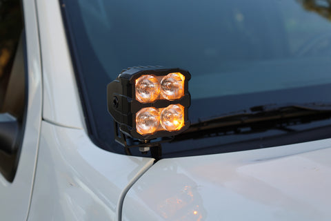 2025+ Nissan Frontier ditch lights PRO mounted on white vehicle, featuring amber daytime running lights.
