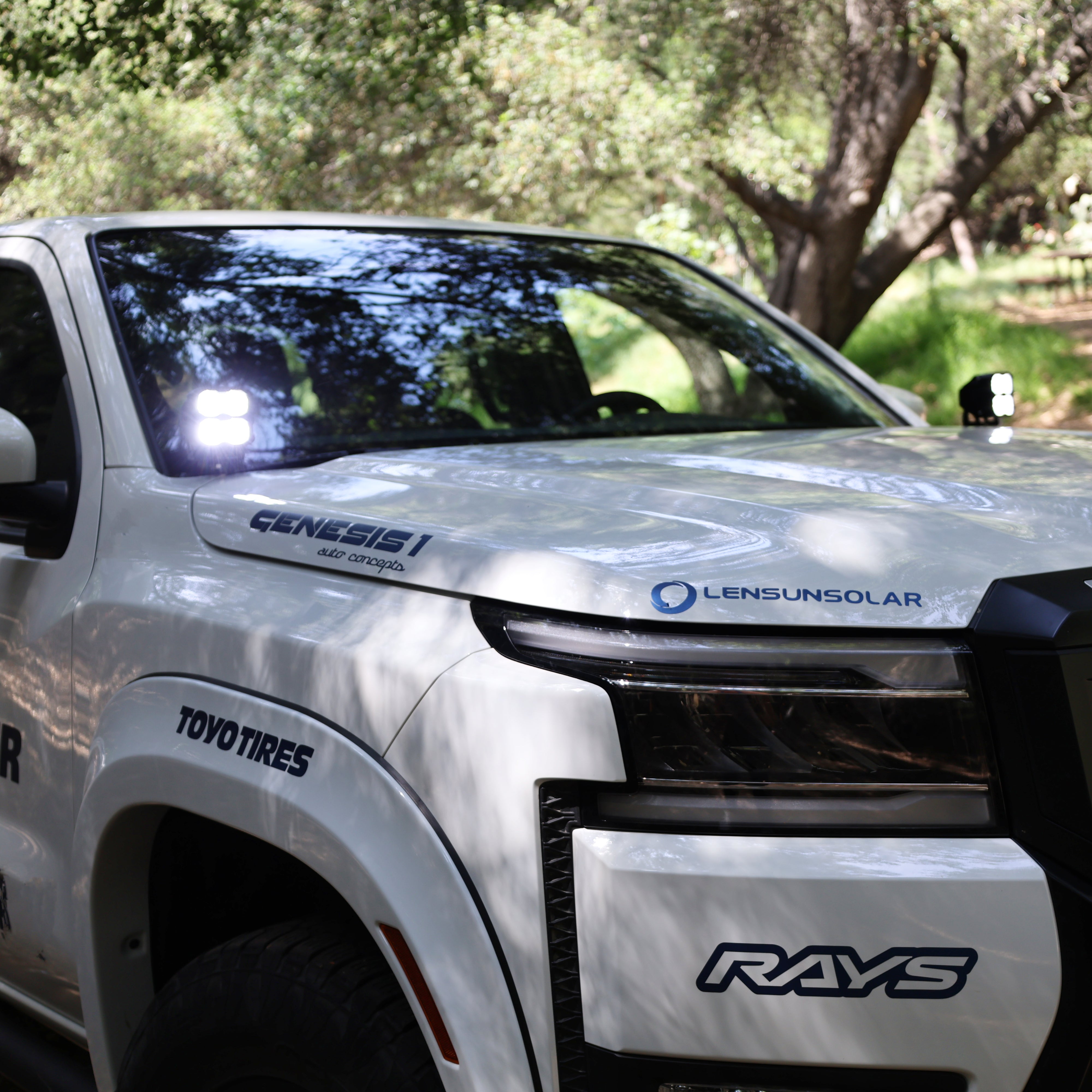 2025+ Nissan Frontier Ditch Lights PRO on a white truck with a greenery background, showcasing Silverado 1500 ditch lights.