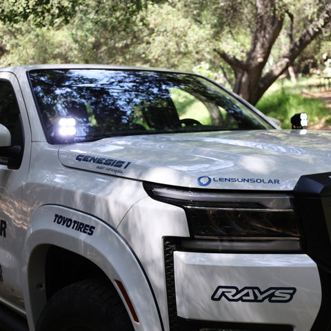 2025+ Nissan Frontier Ditch Lights PRO on a white truck with a greenery background, showcasing Silverado 1500 ditch lights.
