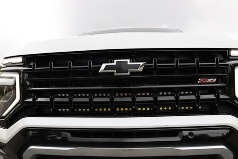 Front view of a Chevrolet Suburban with dual light bars installed, showcasing the grille and lighting functionality for Suburban Light Bars.