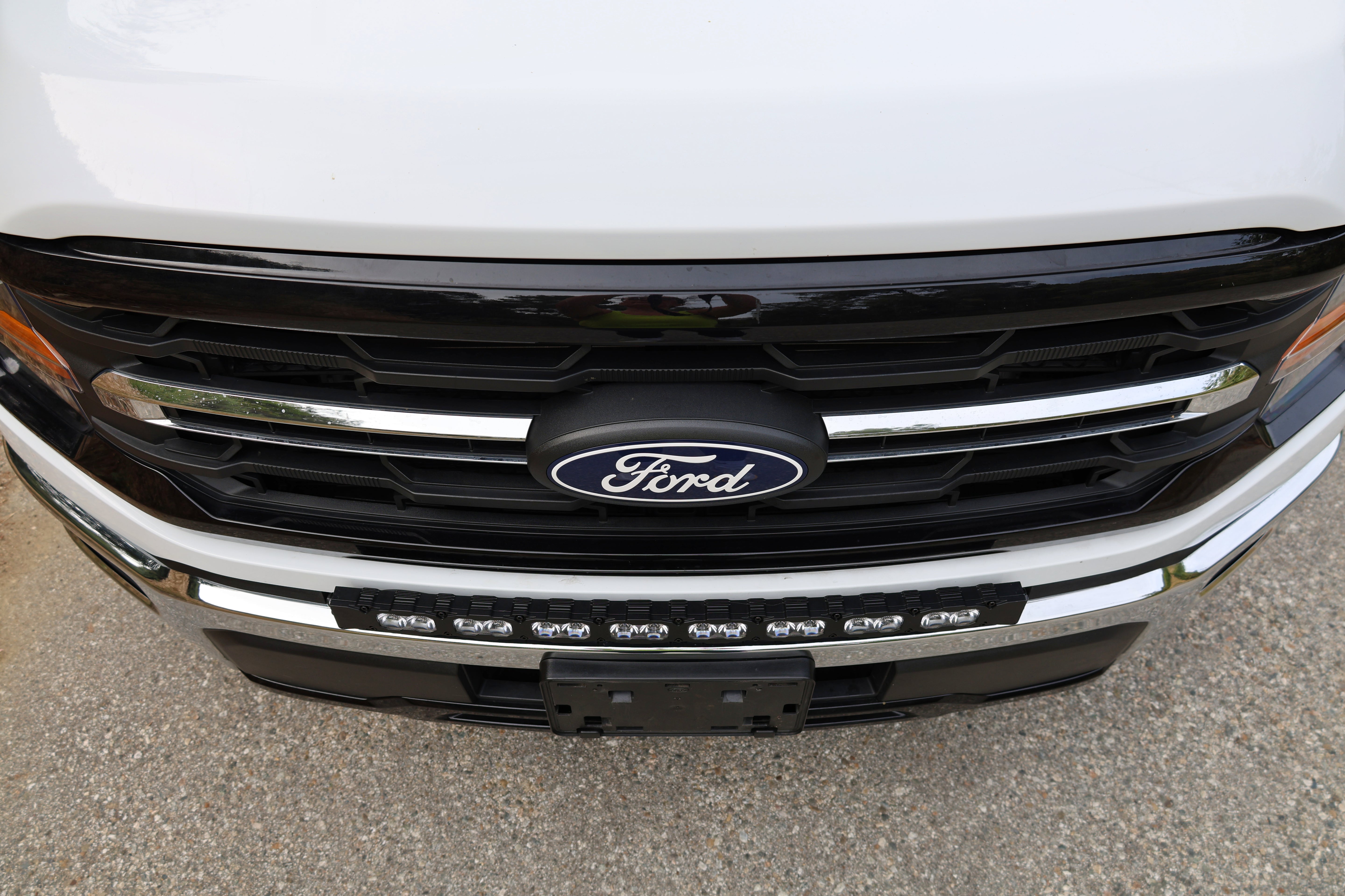 2024+ Ford F150 LightBar installed on the front grille of a Ford truck, showcasing its sleek design and bright illumination.