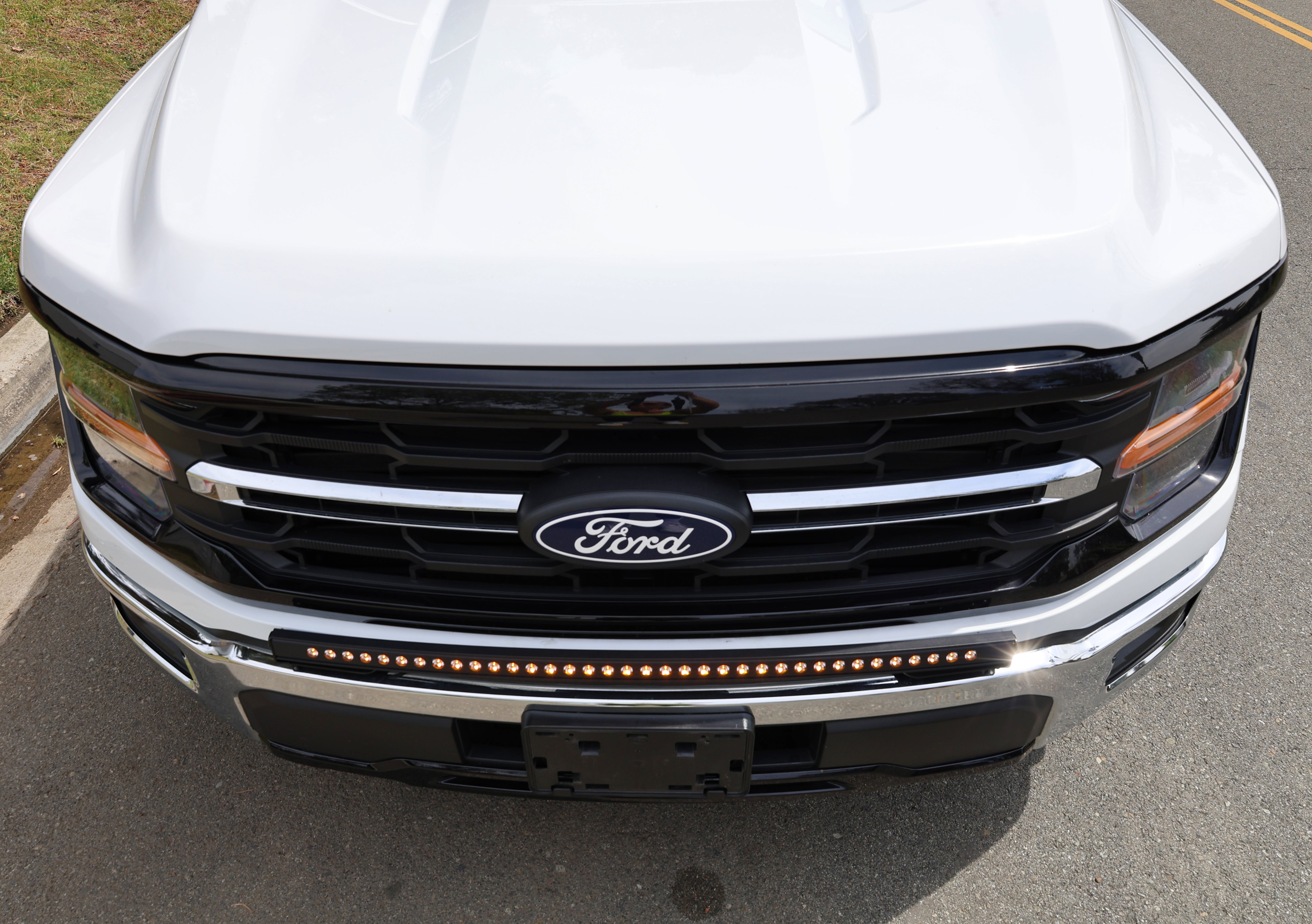 2024+ Ford F150 LightBar mounted on the front grille of a 2024 Ford F150, showcasing its sleek design and powerful lighting.