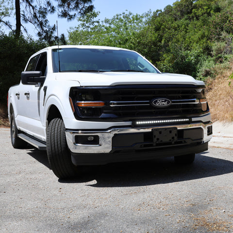 2024+ Ford F150 LightBar installed on a white Ford F150 in a natural outdoor setting.