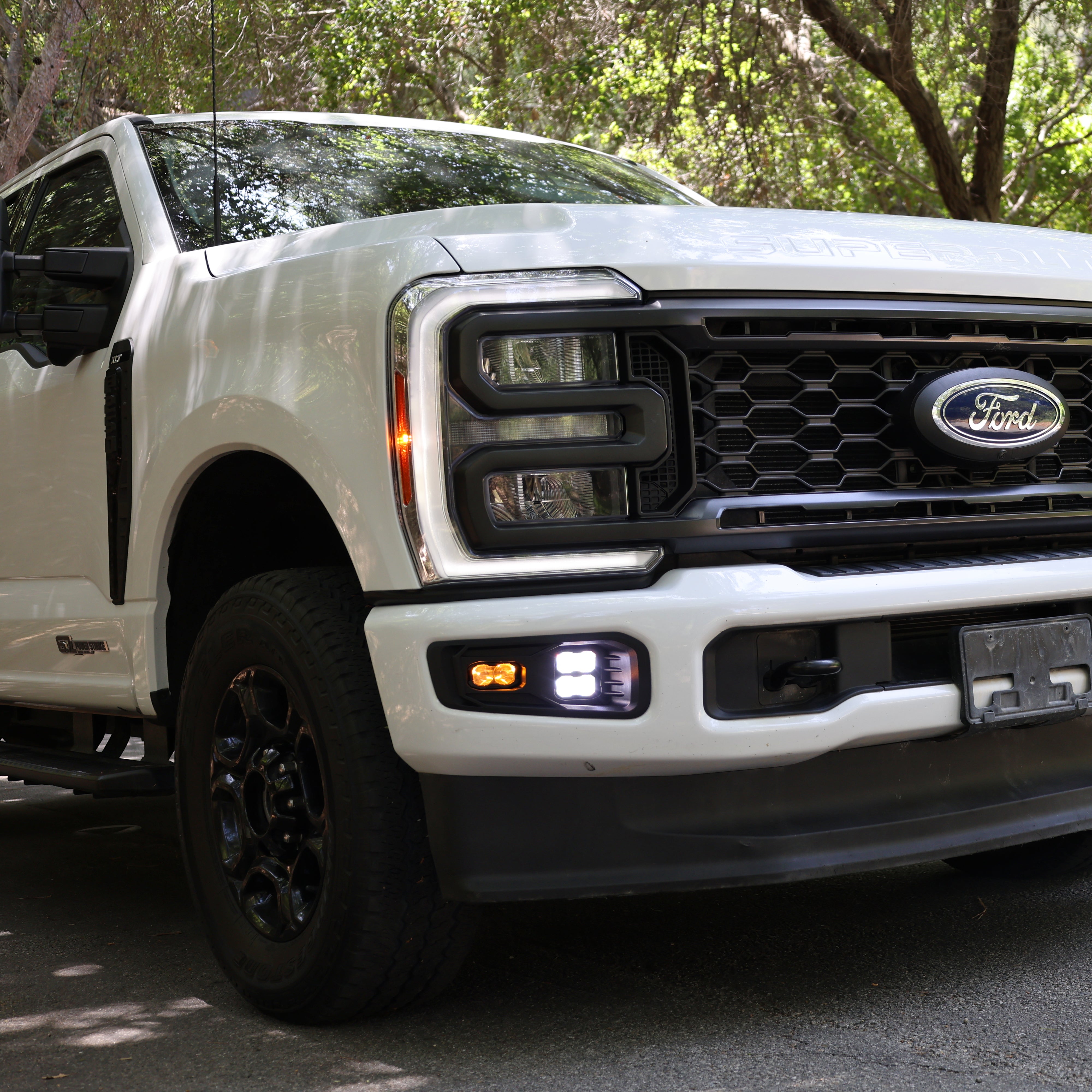 2023 Ford Super Duty Fog Lights installed on a white Ford F250, showcasing enhanced visibility and modern design.