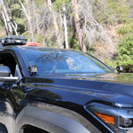 4Runner Ditch lights dual color installed on 2025 Toyota 4Runner SUV parked outdoors in daylight forest setting