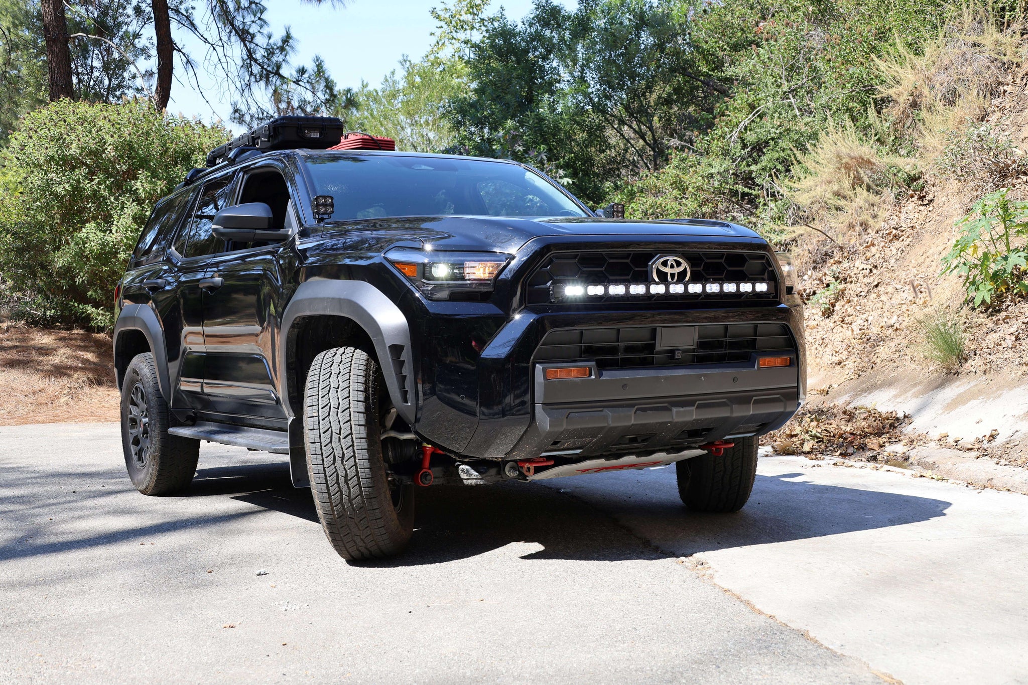 4Runner Light Bar PRO 40in curved LED grille light bar on black 2025 Toyota 4Runner TRD Off-Road parked on forest road