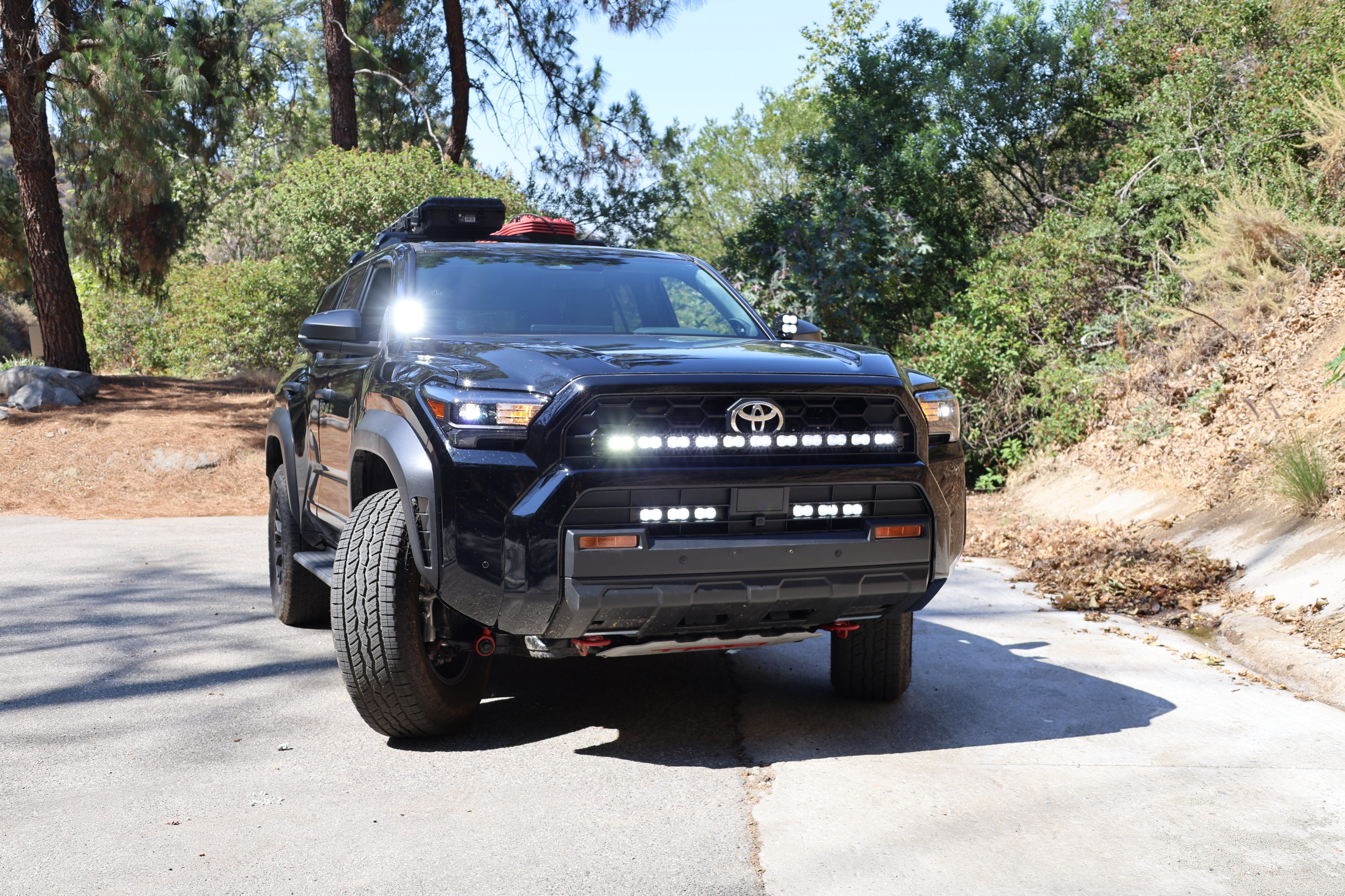 4Runner Light Bar installed on black 2025 Toyota 4Runner TRD grille front view on trail road