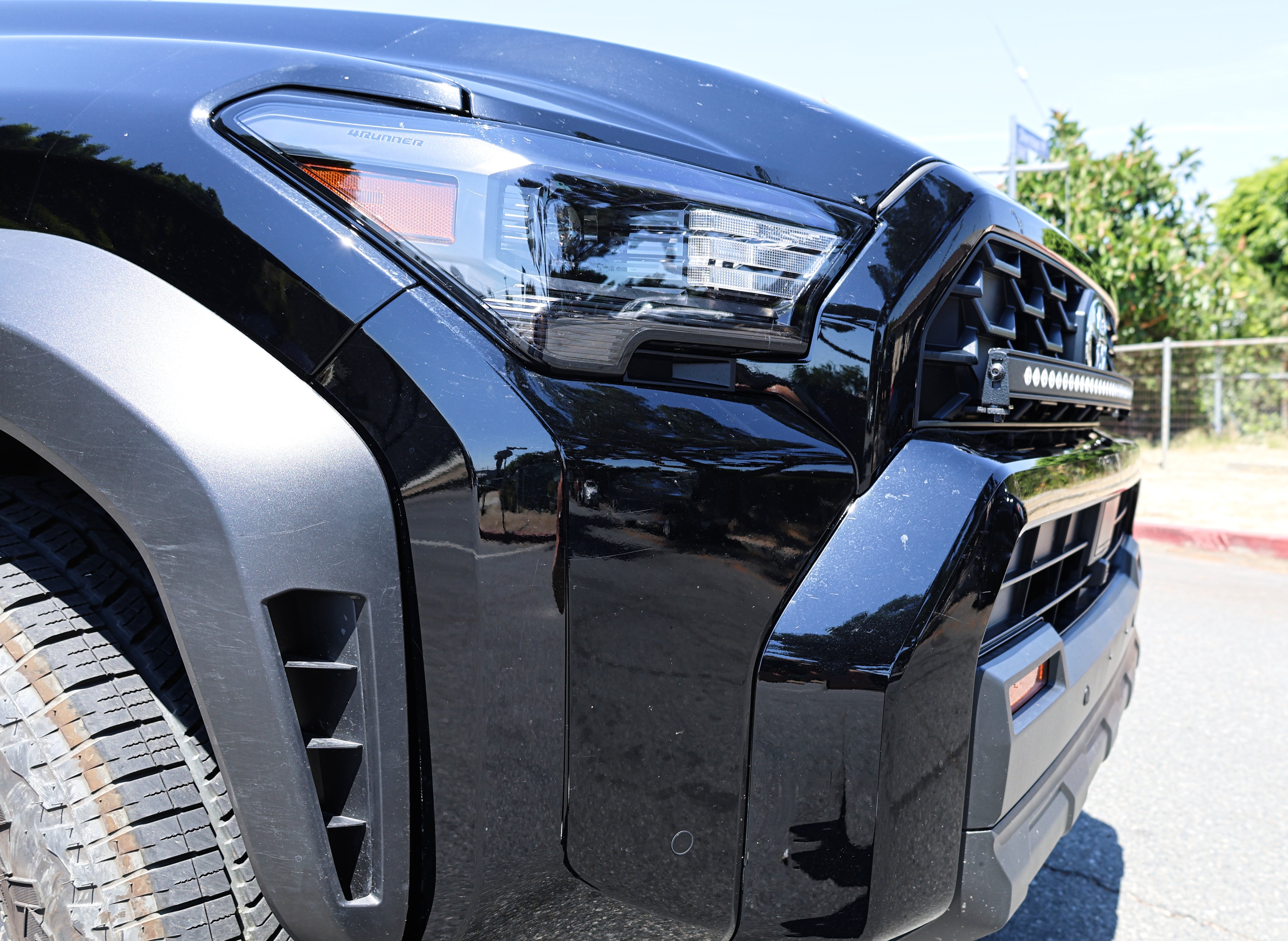 4Runner Light Bar installed on front grille of black 2025 Toyota 4Runner TRD, slim curved 40in LED bar close-up