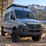 2019+ Mercedes Sprinter 4x4 van with a 40in SLIM LED light bar lit white on top of the grille, mountain lake behind