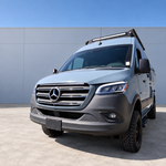 Front view of a 2019+ Mercedes Sprinter 4x4 van with ditch light pods mounted at the base of both side mirrors