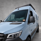 2019+ Mercedes Sprinter van with a ditch light glowing amber at the base of the side mirror