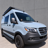 Front three-quarter view of a 2019+ Mercedes Sprinter 4x4 van with ditch light pods at the base of both mirrors