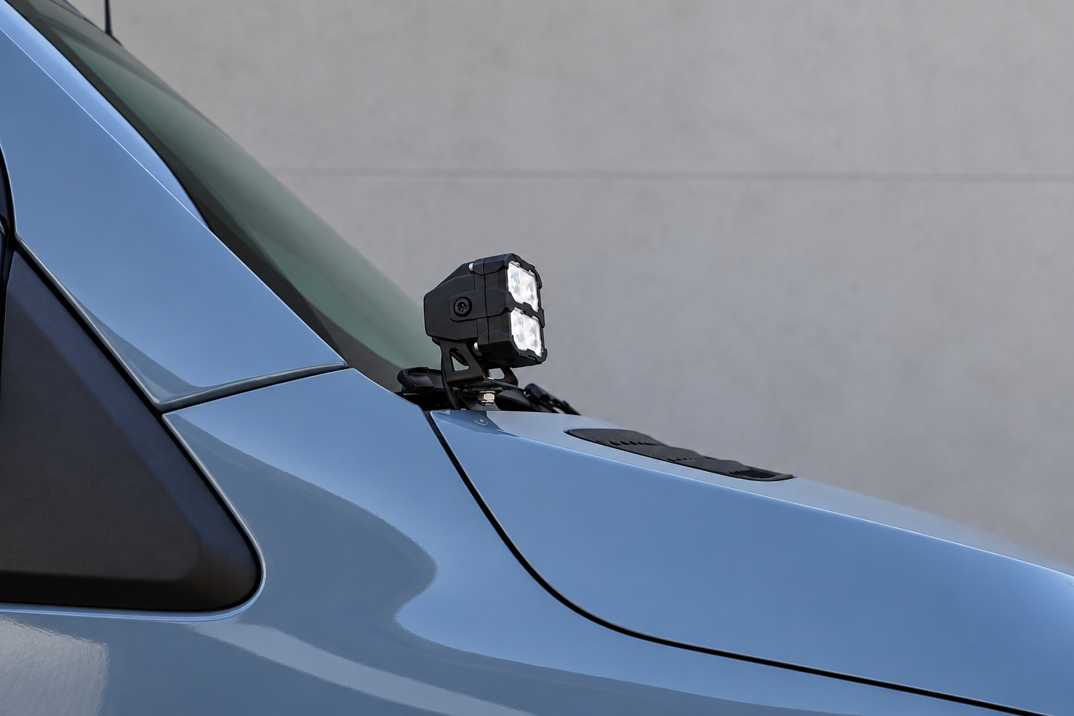Side close-up of a 2019+ Mercedes Sprinter Ditch Lights PRO pod and metal bracket bolted at the mirror base, no drilling