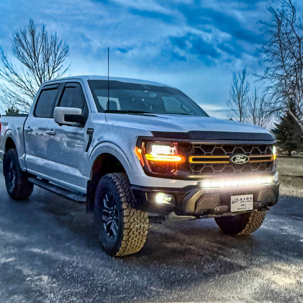 F150 Tremor Modular Bumper 40in Light Bar on white Ford F-150 Tremor pickup with LED lights, rugged tires, front grille, snowy background