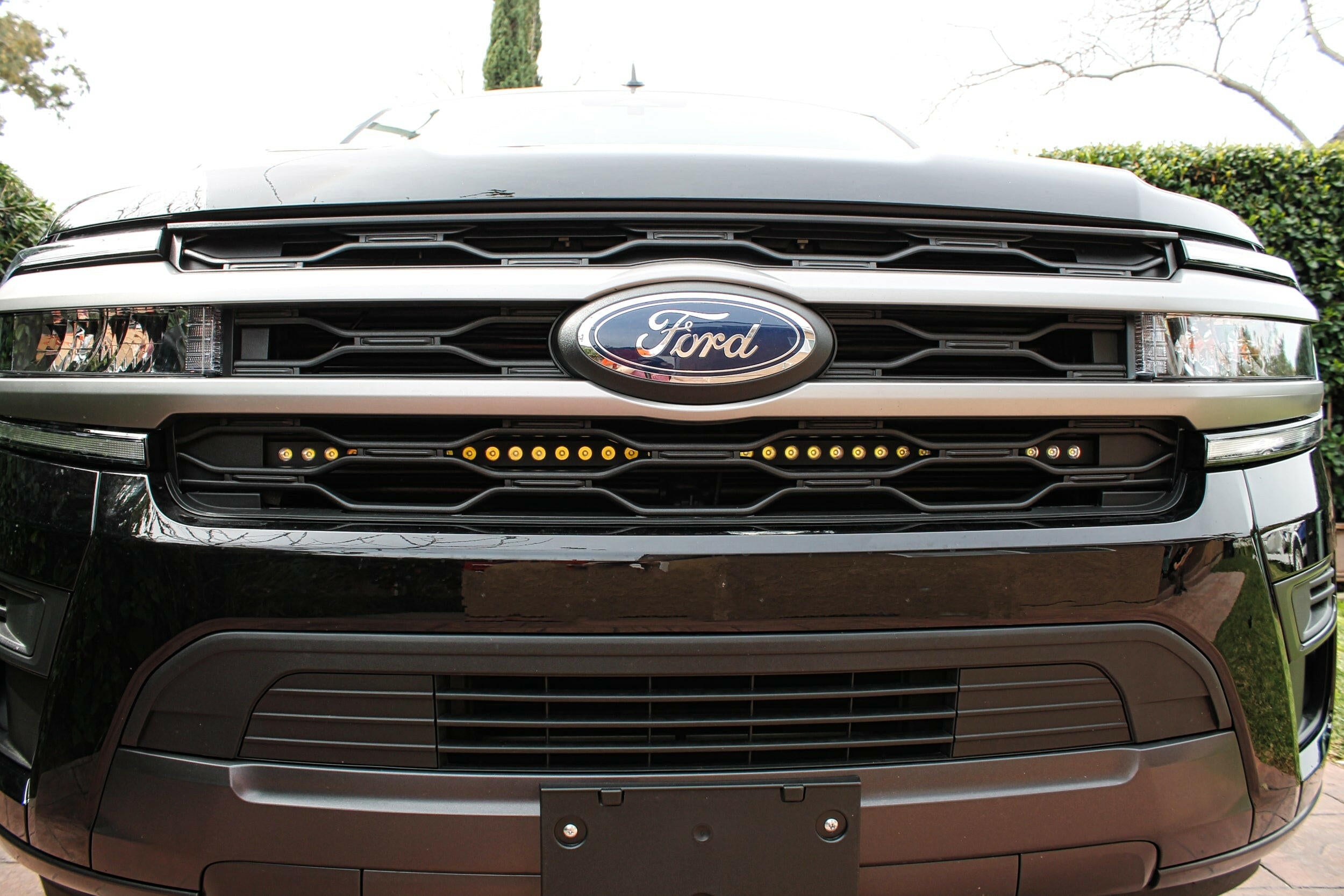 front view of black ford expedition with behind grille led light bar for off roading