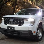 Ford Maverick XL with 23in curved ford maverick light bar installed in front grille on forest road