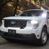 Ford Maverick XL with 23in curved ford maverick light bar installed in front grille on forest road