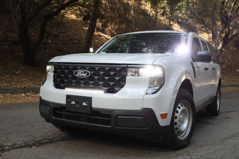 Ford Maverick XL with 23in curved ford maverick light bar installed in front grille on forest road