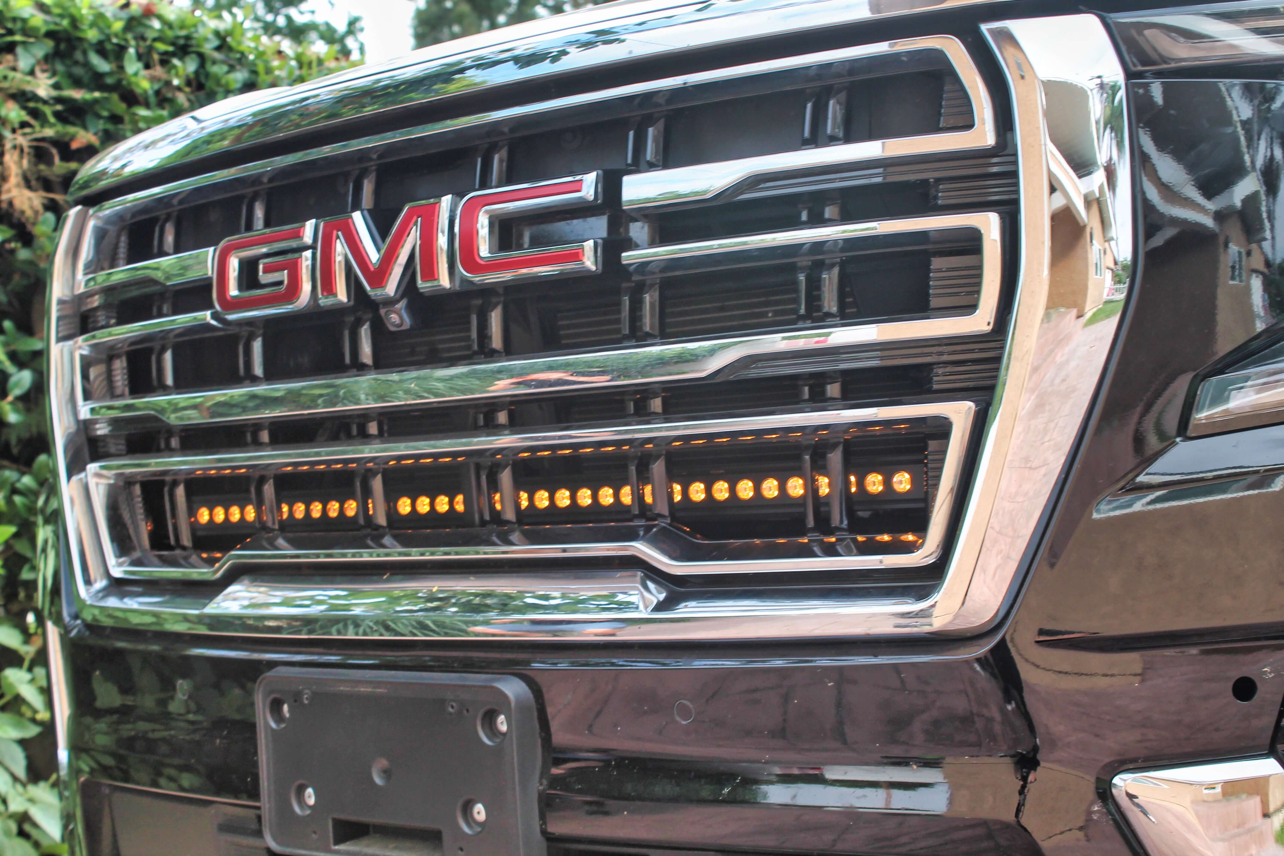 GMC Yukon 2021-24 Single 40in Light Bar installed under GMC logo on the front grille of a black GMC Yukon.