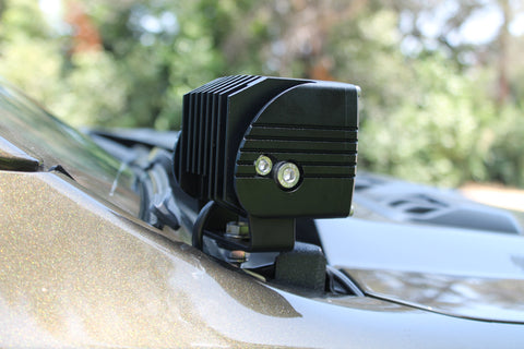 Black LED hood mount light on a 2024 Ford Ranger Raptor, showcasing dual function white and amber backglow.