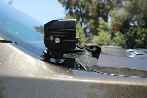 Close-up of 2024 Ford Ranger Raptor hood mount LED light with dual function white and amber DRL backglow.