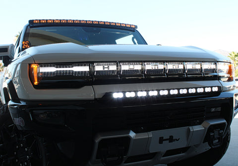 white hummer ev with amber drl roof light bar, white bumper light bar and ditch lights