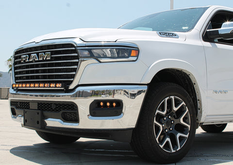 white 2025 ram 1500 with LED light bar on top bumper and fog lights