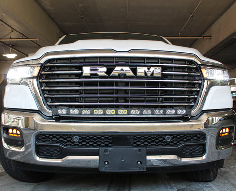 white 2025 ram 1500 with LED light bar on top bumper and fog lights amber