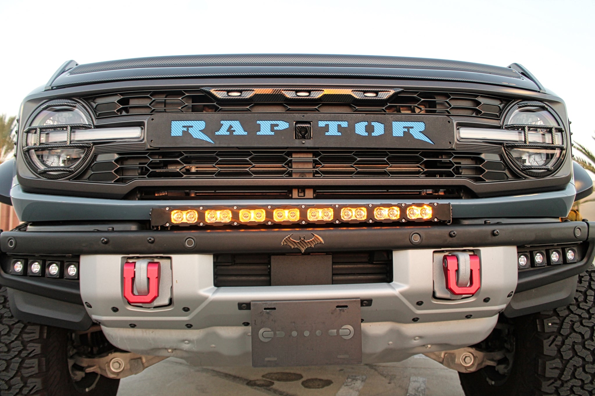 upclose view ford bronco raptor bumper and grille with led light bar amber