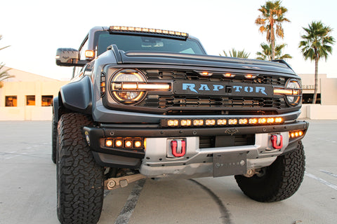 gray ford bronco raptor with LED curved light bar amber color on top fo bumper and roof light bar and fog lights for off roading by M&r automotive