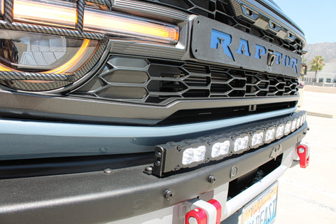 side view ford bronco raptor with white curved led light bar on top of bumpe