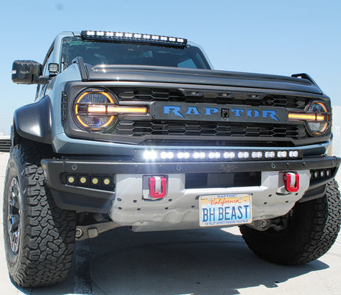 front view ford bronco raptor with white led light bar on bumper and roof plus fog lights