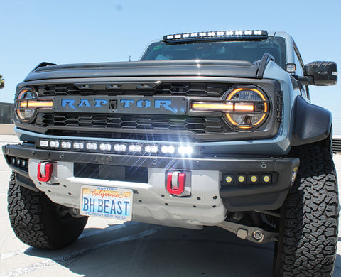 front view ford bronco raptor with white led light bar on bumper and roof plus fog lights