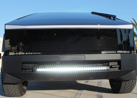 front view black tesla cybertruck with white curved LED light bar in the bumper