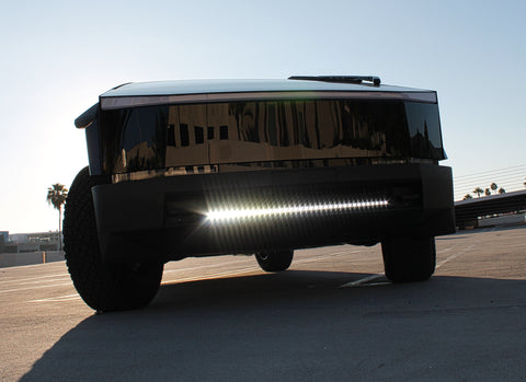 black tesla cybertruck with white curved LED light bar in the bumper