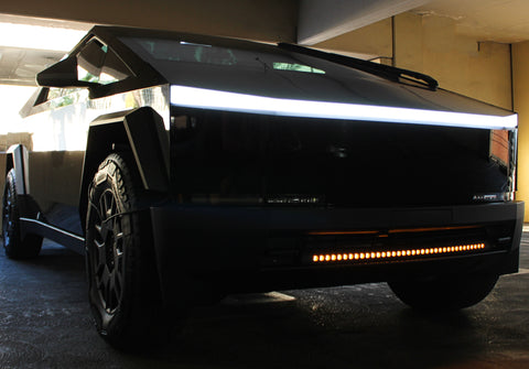 black tesla cybertruck with amber curved LED light bar in the bumper