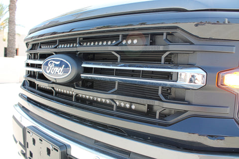 close up 2024 ford f150 with 2 led light bars behind the grille