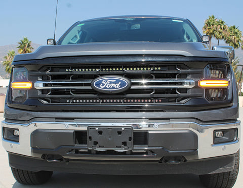 front view ford f150 with 2 led light bars behind the grille and ditch lights