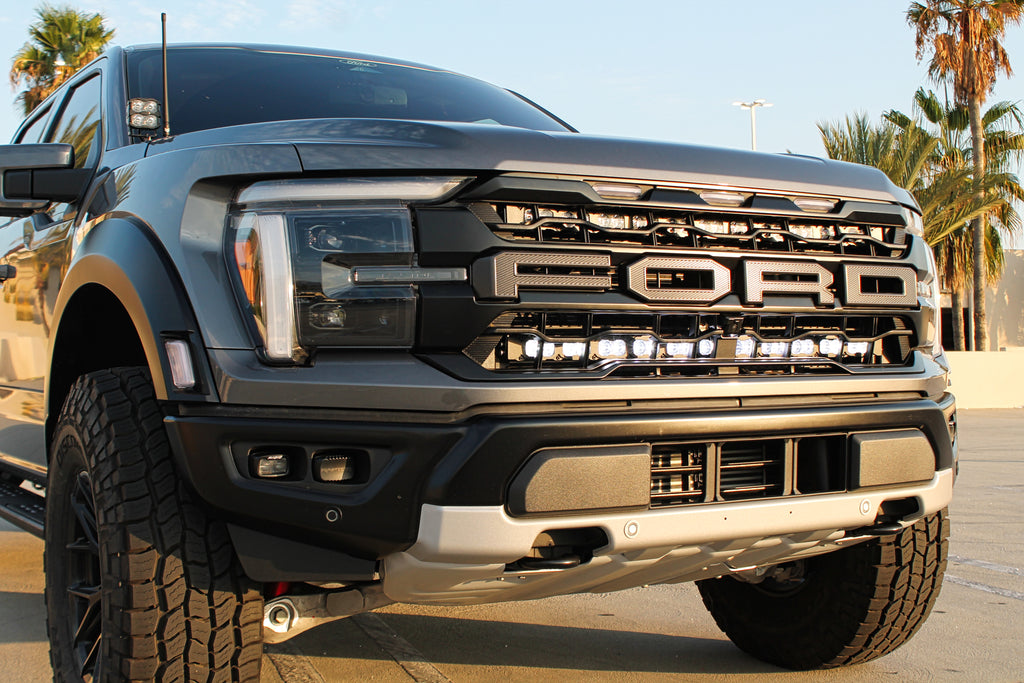 gray 2024 ford raptor gen 3 with  white behind the grille and ditch lights for off roading