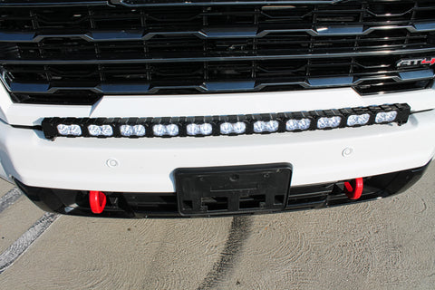 up close view of white gmc sierra 2500 3500 HD with a curved LED light bar in front of the grille