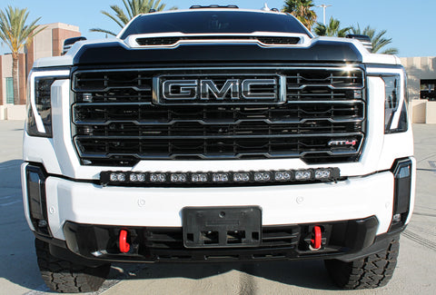 white gmc sierra 2500 3500 HD with a curved LED light bar in front of the grille