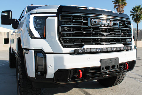 white gmc sierra 2500 3500 HD with a curved LED light bar in front of the grille