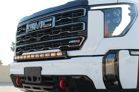 white gmc sierra 2500 3500 HD with a curved LED light bar in front of the grille