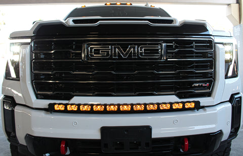 white gmc sierra 2500 3500 HD with a curved LED light bar in front of the grille