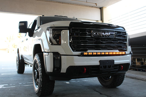 white gmc sierra 2500 3500 HD with a curved LED light bar in front of the grille