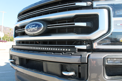 up close view of 2021 gray ford super duty with LED light bar on the bumper