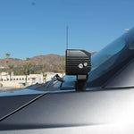 Ford Super Duty ditch lights mounted on a 2020-2022 F-Series truck, side view of the dash area with a rugged black lighting fixture and vehicle windshield